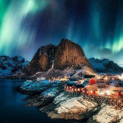 Aurora borealis, Northern lights over mountain with fishing vill